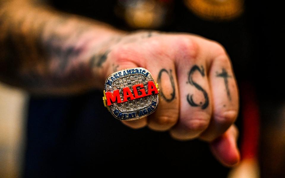 A supporter of Donald Trump wears a MAGA ring as he attends a Super Tuesday election night watch party