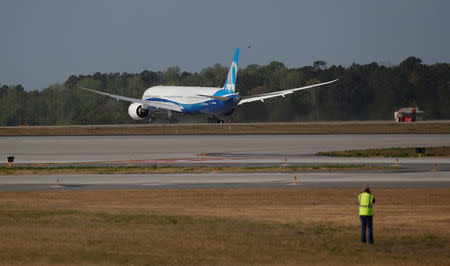 A photographer takes a photo during the first flight of the new Boeing 787-10 Dreamliner at the Charleston International Airport in North Charleston, South Carolina, United States March 31, 2017. REUTERS/Randall Hill