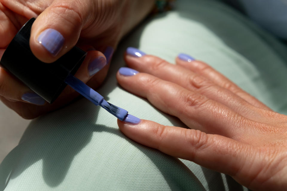 person painting their nails