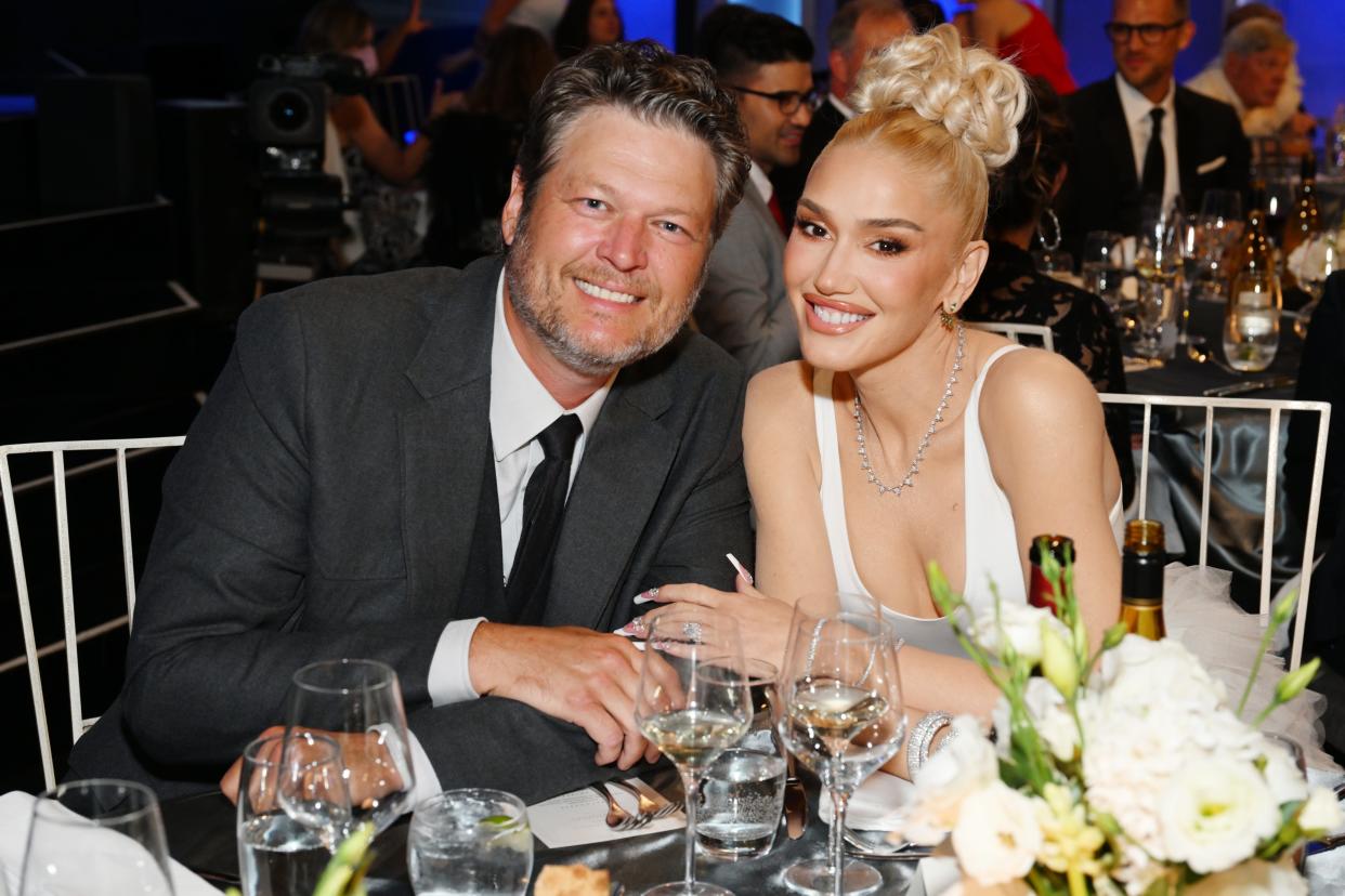 Blake Shelton and Gwen Stefani hold hands and smile at the AFI Life Achievement Award Gala