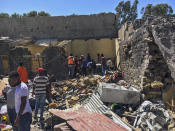 Residents sift through rubble from a destroyed building at the scene of an airstrike in Mekele, in the Tigray region of northern Ethiopia Thursday, Oct. 28, 2021. An Ethiopian government spokesman says a new airstrike has hit Mekele, targeting a site used by rival Tigray forces to make and repair weapons, while a Tigray spokesman instead says it struck a "civilian residence" killing six people and wounding more than 20. (AP Photo)