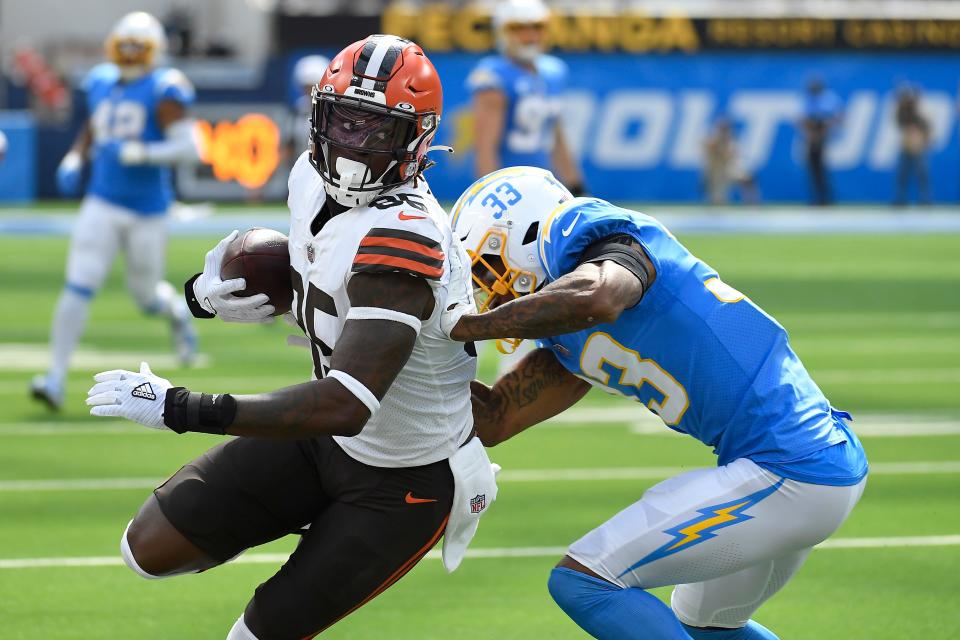 Cleveland Browns tight end David Njoku (85) runs past Los Angeles Chargers free safety Derwin James (33) after a catch during the first half of an NFL football game Sunday, Oct. 10, 2021, in Inglewood, Calif. (AP Photo/Kevork Djansezian)
