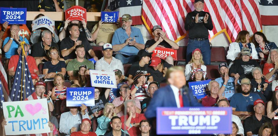 Fans listen as former U.S. President Donald Trump speaks during a campaign rally in Erie on July 29, 2023.