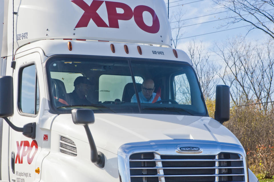 XPO Logistics CEO Brad Jacobs, right, gets instructions from company driver Antoine Seegars, left, sitting in the driver's seat of a special tractor-trailer commemorating XPO Logistics' recent acquisition of Con-way, Monday, Nov. 2, 2015, in Ann Arbor, Mich. The trailer will be driven across the country on a nationwide social media tour. (Tony Ding/AP Images for XPO Logistics)