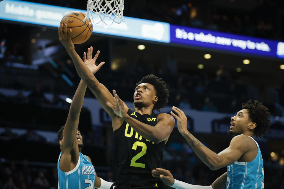 Utah Jazz guard Collin Sexton (2) drives to the basket between Charlotte Hornets forwards Brandon Miller, left, and Leaky Black during the first half of an NBA basketball game in Charlotte, N.C., Saturday, Jan. 27, 2024. (AP Photo/Nell Redmond)