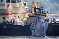 <p>Officials remove a plane from the Hudson River a day after it crashed, Saturday, May 28, 2016, in North Bergen, N.J. The World War II vintage P-47 Thunderbolt aircraft crashed into the river Friday, May 27, 2016, killing its pilot. (AP Photo/Julio Cortez) </p>