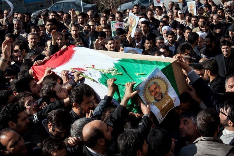 Iranians carry the coffin of a commander shot dead in Syria, during his funeral procession in Tehran on February 14, 2013. Syria's rebels captured a military airbase in the northern province of Aleppo and geared for a major battle against loyalist forces for control of two nearby strategic airports