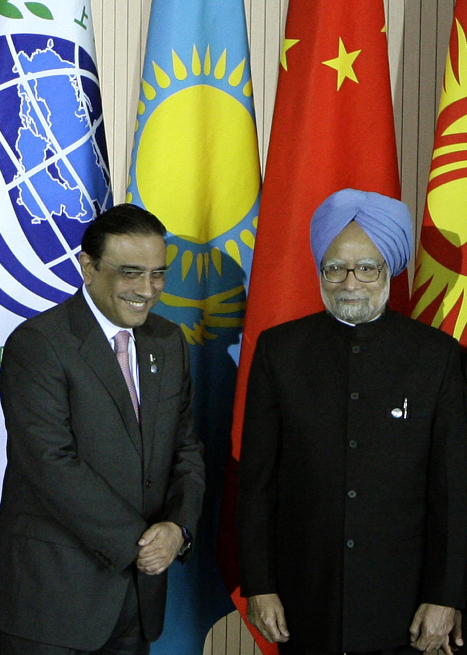 FILE - In this June 16, 2009 file photo, Pakistan's President Asif Ali Zardari, left, and Indian Prime Minister Manmohan Singh pose for a photo during a summit of the Shanghai Cooperation Organization in the Ural Mountains city of Yekaterinburg, Russia. Zardari's trip to India on Sunday, April 8, 2012, is a milestone in the warming relations between the neighbors. But, officially, he is just sharing a quick lunch with the India's leader on his way to visit a Muslim shrine. (AP Photo/Mikhail Metzel, File)