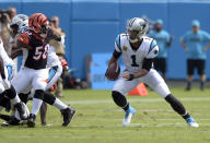 Carolina Panthers' Cam Newton (1) scrambles against the Cincinnati Bengals during the first half of an NFL football game in Charlotte, N.C., Sunday, Sept. 23, 2018. (AP Photo/Mike McCarn)