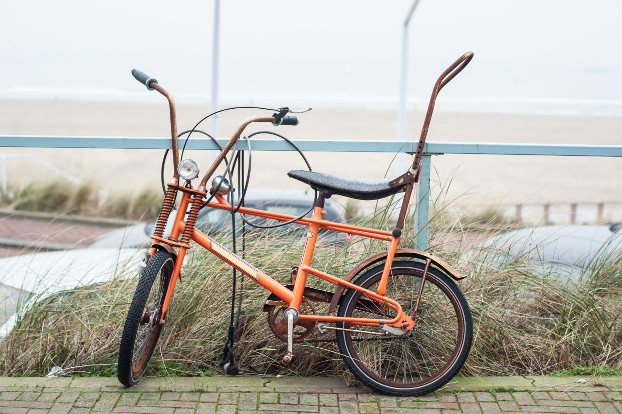 Old holland classic banana seat bicycle vintage bicycle in public. Cityscape view. Dutch lifestyle