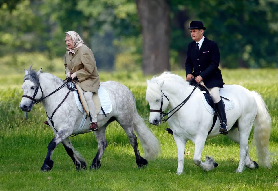 <p>As an avid horseback rider, it isn't rare for the Queen to enjoy a ride in the saddle — <a href="https://www.usatoday.com/story/entertainment/celebrities/2020/05/31/queen-elizabeth-rides-horse-emerges-coronavirus-quarantine-windsor-castle/5301424002/" rel="nofollow noopener" target="_blank" data-ylk="slk:even at the age of 96;elm:context_link;itc:0;sec:content-canvas" class="link ">even at the age of 96</a>. At the end of the day, she's just your normal horse lover. Here, she rides at Windsor Castle in 2006. </p>