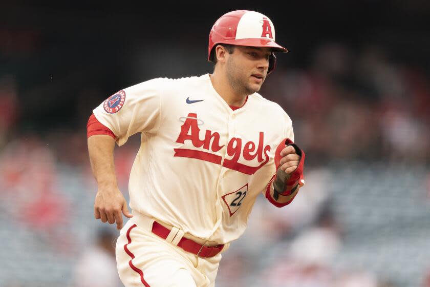 Los Angeles Angels' David Fletcher runs to third base off a ground ball hit by Jared Walsh.