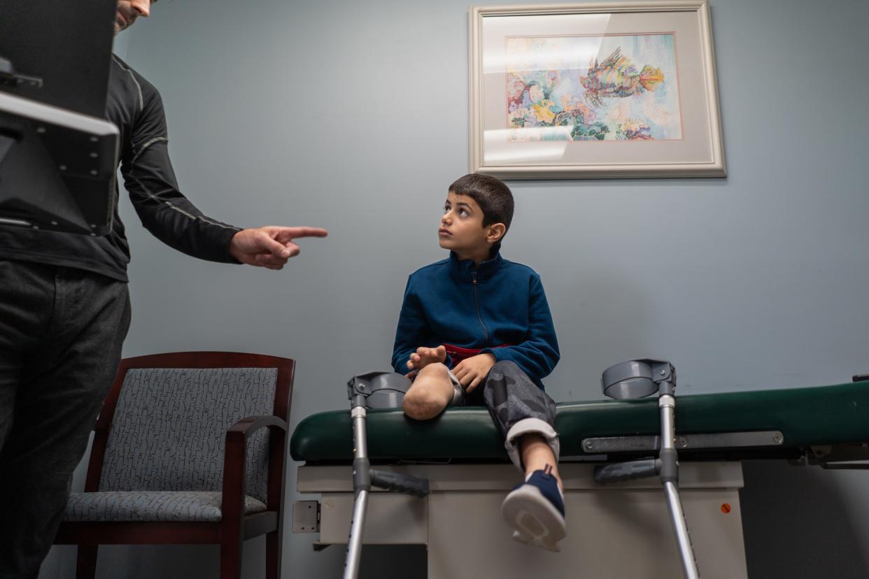 Saleh Humaid, 8, of Gaza listens as Anew Life Prosthetics and Orthotics Prosthetist & Orthotist Matt Warner goes over the steps towards getting him fitted for a prosthetic leg that his company is donating to Humaid on Tuesday, June 13, 2023, during his trip to the United States with the help of the Palestine Children's Relief Fund to get him therapy and the new high-quality prosthetic he couldn't get back home.