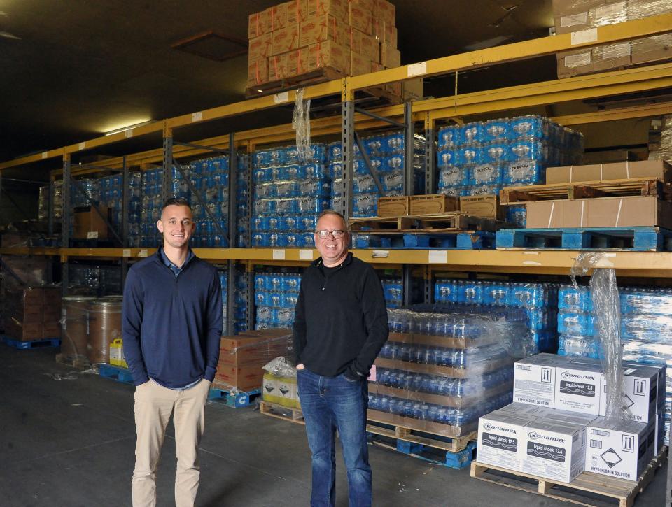 Austin Miller and Matt Plocki are the new owners of Friendly Wholesale in Wooster. They are in a large warehouse with pallets of items ready to be shipped to customers. It is one of three buildings they call the OB (Other Building) on the Friendly Wholesale campus used for overflow inventory. The buildings they call the State Building and Vending Building also hold overflow inventory.