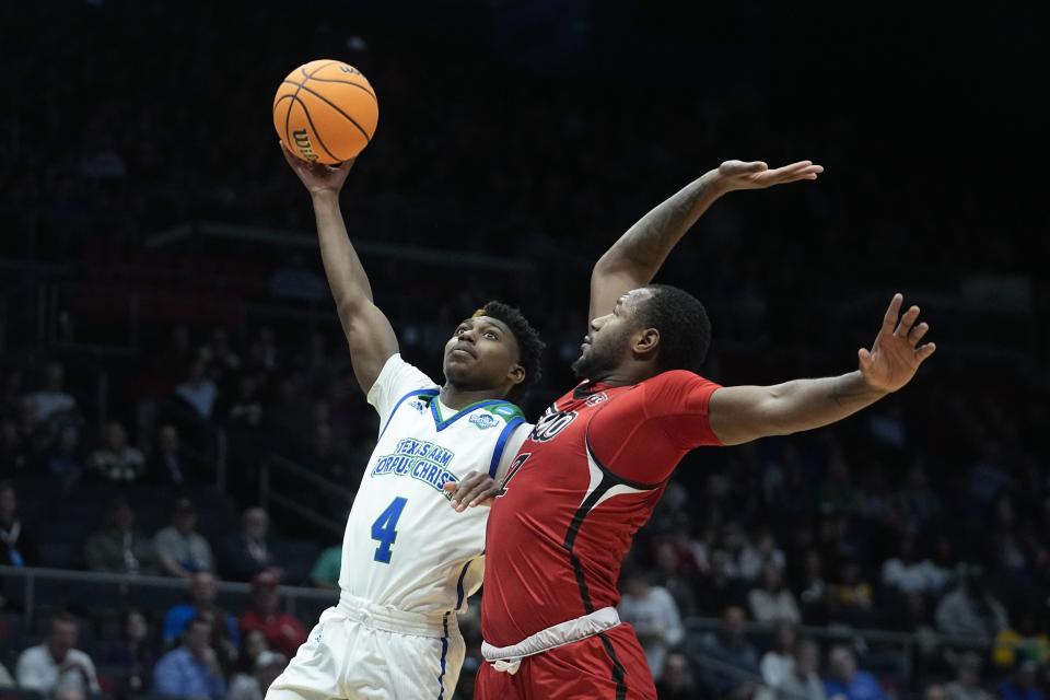 Texas A&M Corpus Christi's Jalen Jackson (4) shoots against Southeast Missouri State's Phillip Russell (1) during the first half of a First Four college basketball game in the NCAA men's basketball tournament, Tuesday, March 14, 2023, in Dayton, Ohio. (AP Photo/Darron Cummings)