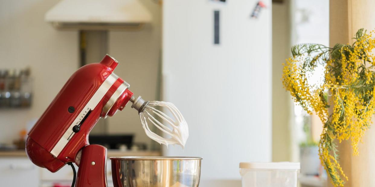 red stand mixer mixing cream