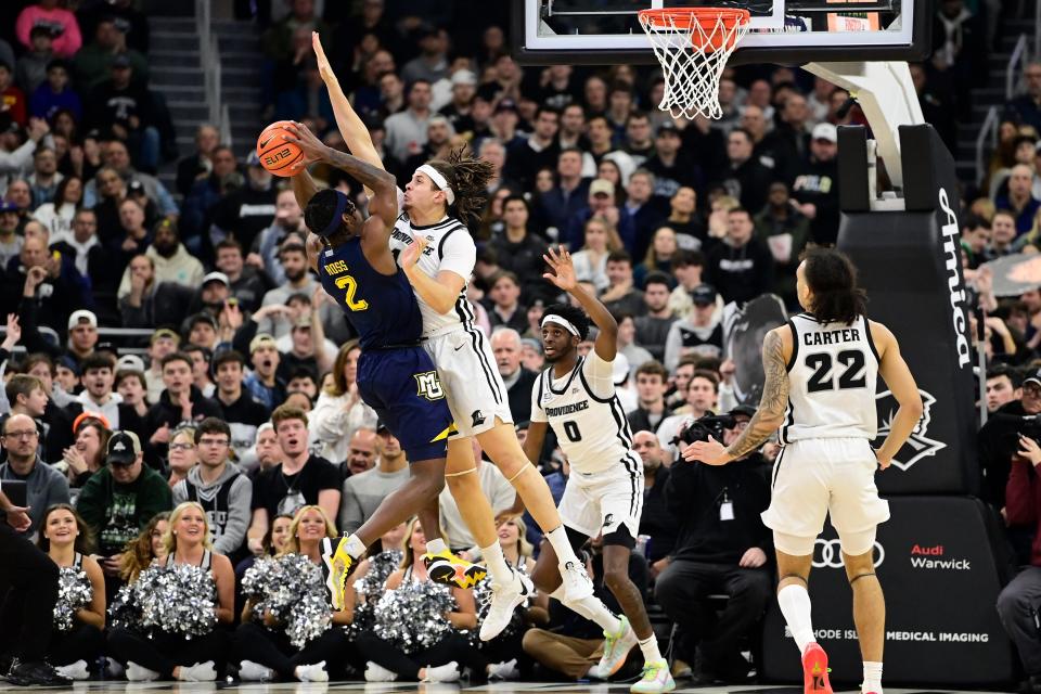 Providence forward Josh Oduro defends against Marquette guard Chase Ross during the first half Tuesday night at Amica Mutual Pavilion.