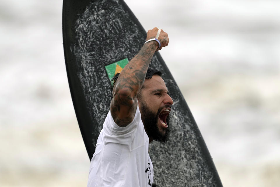 Brazil's Italo Ferreira celebrates winning the gold medal in the men's surfing competition at the 2020 Summer Olympics, Tuesday, July 27, 2021, at Tsurigasaki beach in Ichinomiya, Japan. (AP Photo/Francisco Seco)