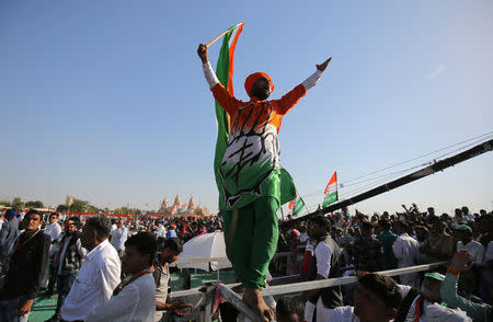 A supporter of India's main opposition Congress party shouts slogans as he waves the party flag during a public meeting in Gandhinagar, Gujarat, India, March 12, 2019. REUTERS/Amit Dave