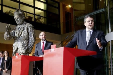 German Economy Minister and Leader of the Social Democratic Party (SPD) Sigmar Gabriel speaks next to Martin Schulz, former president of the European Parliament as they stand beside a statue of Willy Brandt, former German Chancellor during a news conference in Berlin, Germany, January 24, 2017. REUTERS/Fabrizio Bensch