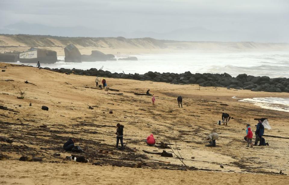 People walk on the beach on November 11, 2019 in Capbreton, southwestern France, where cocaine packages have been found. Source: AFP