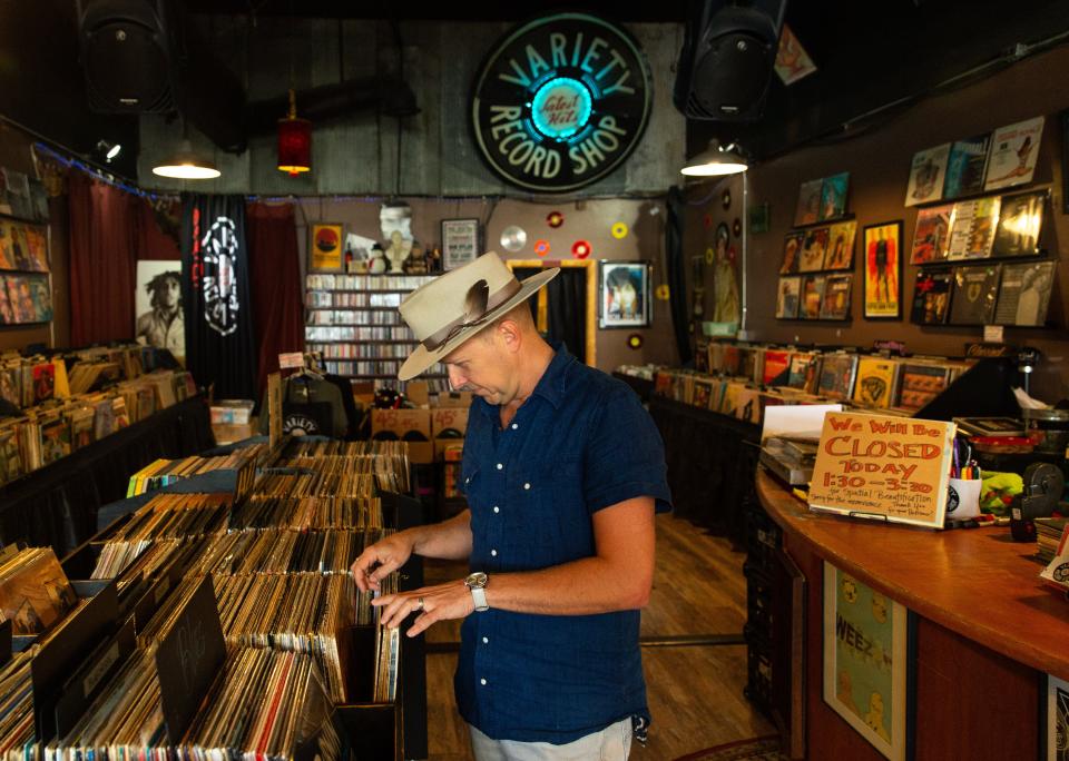 Gabe McCauley, the host of the PBS show "Reconnecting Roots" browses albums at Variety Record Shop in Columbia, Tenn. on Aug. 23, 2022. Gabe and his wife Mandy, the show's music supervisor, recently released a Volume II vinyl of reimagined songs used on their show.