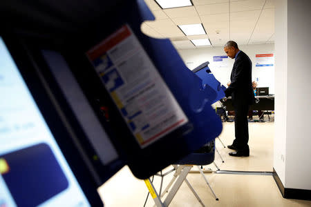 U.S. President Barack Obama casts his vote for president in early voting at the Cook County Office Building in Chicago, Illinois, U.S. October 7, 2016. REUTERS/Jonathan Ernst