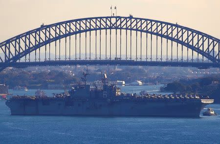 The USS Bonhomme Richard amphibious assault ship manoeuvres into port in front of the Sydney Harbour Bridge in Australia, June 29, 2017 after a ceremony on board the ship marking the start of Talisman Saber 2017, a biennial joint military exercise between the United States and Australia. REUTERS/David Gray