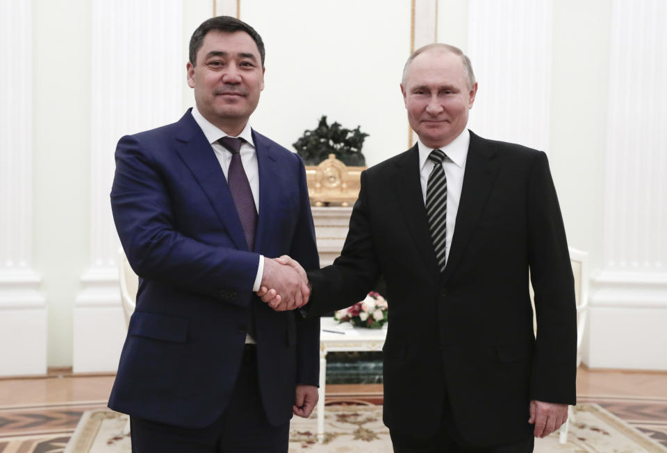 Russian President Vladimir Putin, right, shake hands with Kyrgyzstan's President Sadyr Japarov during their meeting in Moscow, Russia, Wednesday, Feb. 24, 2021. (Mihail Metzel, Sputnik, Kremlin Pool Photo via AP)