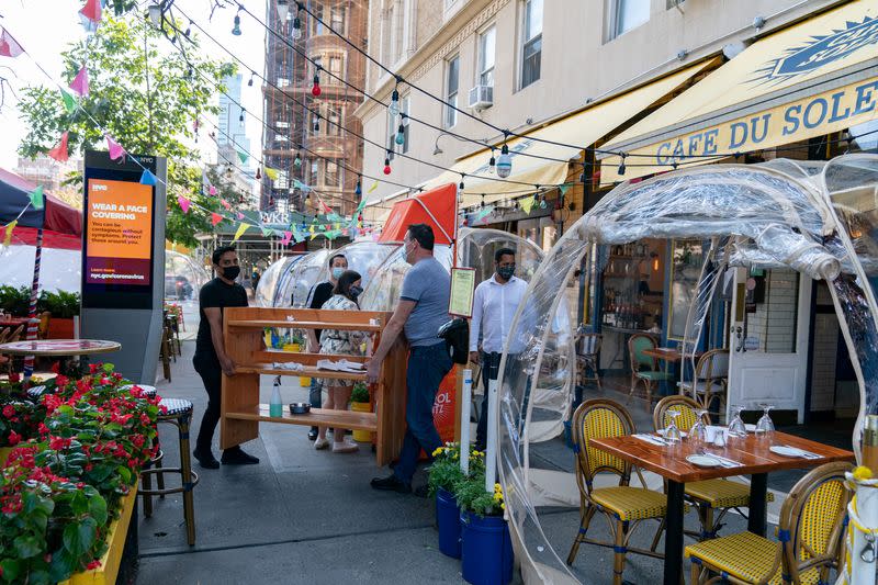 Staff set up bubble tents outside Cafe Du Soliel following the outbreak of the coronavirus disease (COVID-19) in the Manhattan borough of New York City