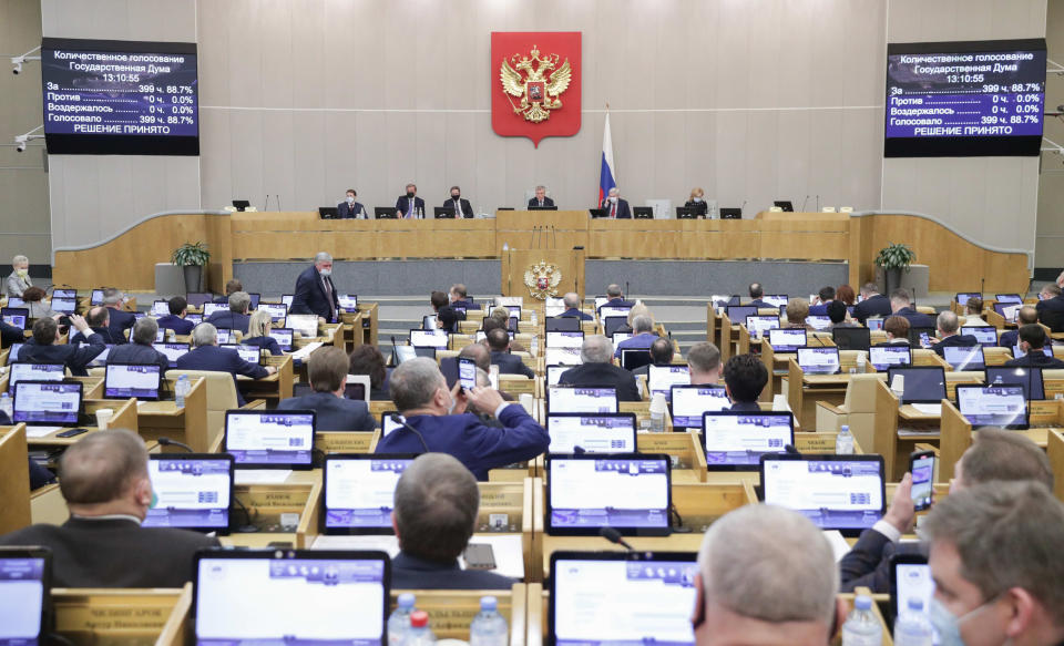 In this photo provided by the State Duma, deputies attend a session at the State Duma, the Lower House of the Russian Parliament in Moscow, Russia, Wednesday, Jan. 27, 2021. Both houses of parliament voted unanimously Wednesday to extend New START treaty for five years, a fast-track move that comes days before the last remaining U.S.-Russian arms control pact is due to expire. (The State Duma, The Federal Assembly of The Russian Federation via AP)