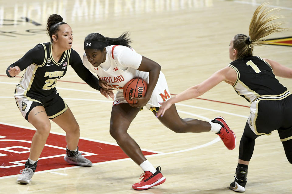 Maryland guard Ashley Owusu (15) drives to the hoop in front of Purdue guards Kayana Traylor (23) and Karissa McLaughlin (1) during the second half of an NCAA college basketball game, Sunday, Jan. 10, 2021, in College Park, Md. (AP Photo/Will Newton)