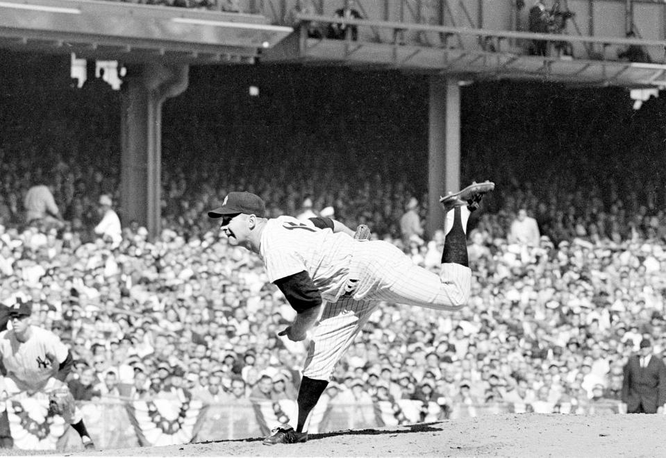 FILE - In this Oct. 8, 1960 file photo, New York Yankees pitcher Whitey Ford throws against the Pittsburgh Pirates in the third World Series game at Yankee Stadium in New York. A family member tells The Associated Press on Friday, Oct. 9, 2020 that Ford died at his Long Island home Thursday night. (AP Photo, File)