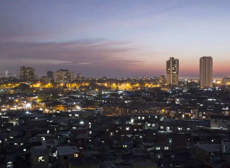 FILE PHOTO: High-rise residential towers are seen behind shanties in Dharavi