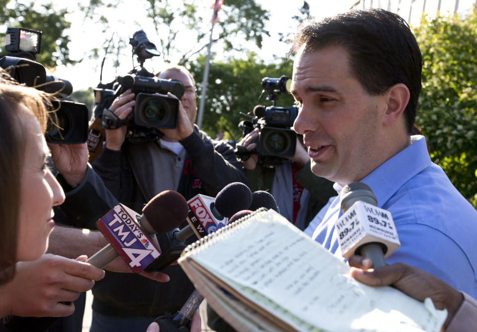 Wisconsin Republican Gov. Scott Walker talks to reporters after voting Tuesday, June 5, 2012, in Wauwatosa, Wis. Walker faces Democratic challenger Tom Barrett in a special recall election. (AP Photo/Morry Gash)