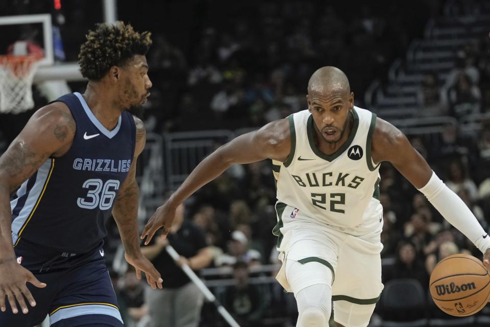 Milwaukee Bucks' Khris Middleton tries to get past Memphis Grizzlies' Marcus Smart during the first half of a preseason NBA basketball game Friday, Oct. 20, 2023, in Milwaukee. (AP Photo/Morry Gash)