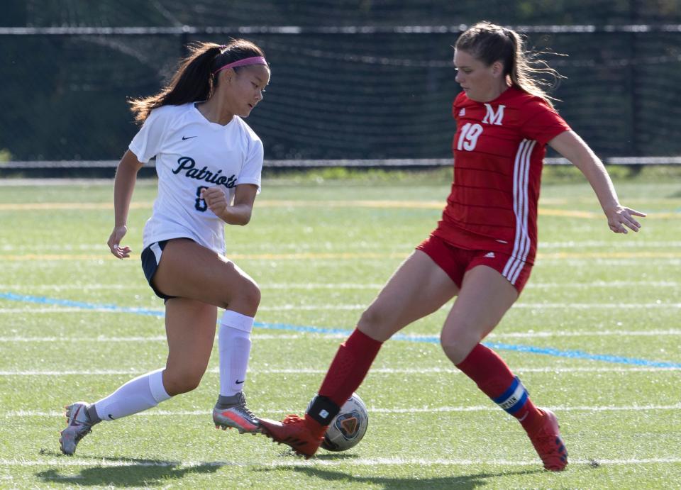 Freehold Kayla Wong and Manalapan Sydney Spilsbury battle for ball at midfield in first half action. Freehold Township Girls Soccer defeats Manalapan 4-0 in Manalapan, NJ on September 20, 2022. 