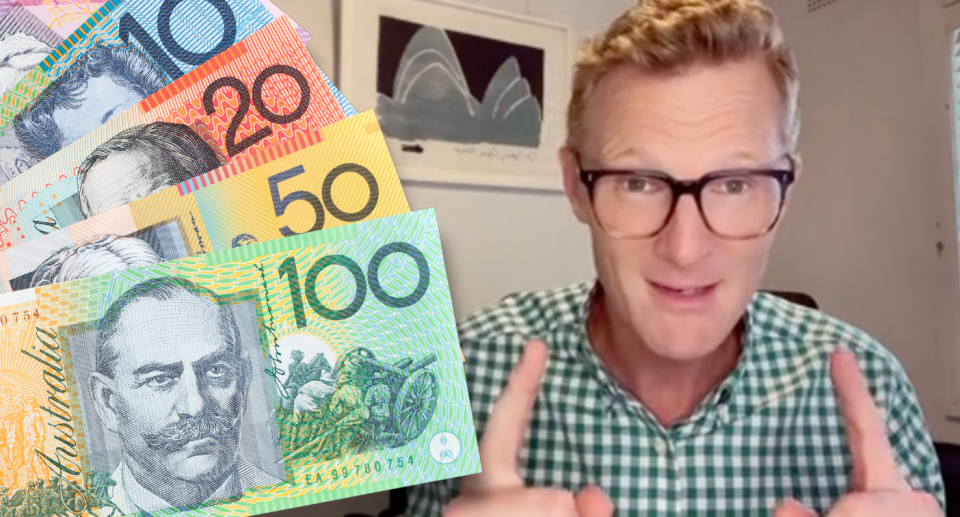 Joel Gibson holding up two fingers with Australian dollar bills on the side. 