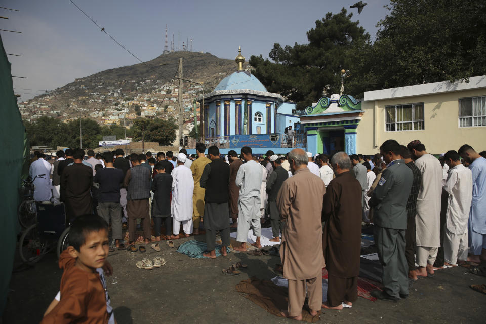 Afghan Muslims offer Eid al-Adha prayers in Kabul, Afghanistan, Sunday, Aug. 11, 2019. Muslim people in the country celebrate Eid al-Adha, or the Feast of the Sacrifice by slaughtering sheep, goats and cows whose meat will later be distributed to the poor.(AP Photo/Rafiq Maqbool)