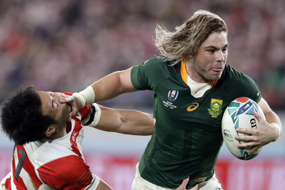 South Africa's Faf de Klerk runs to score a try during the Rugby World Cup quarterfinal match at Tokyo Stadium between Japan and South Africa in Tokyo, Japan, Sunday, Oct. 20, 2019. (AP Photo/Mark Baker)