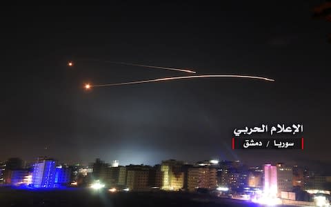 Missiles fire is seen over Damascus - Credit: Reuters