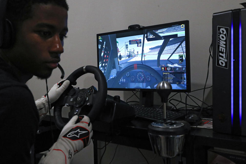 WASHINGTON, DC - MARCH 19: NASCAR Drive For Diversity Driver, Rajah Caruth checks his live-broadcast Twitch stream as he competes in the eTruck Series Night in America Powered by FilterTime, a live-online NASCAR Truck Series race on the iRacing platform, from his bedroom of his parent's home on March 19, 2020 in Washington, DC. The online race was organized by NASCAR Xfinity Series driver Ryan Vargas in response to the global COVID-19 pandemic - benefited multiple charities and included other professional ARCA and NASCAR drivers. Caruth, 17, who is currently racing in the NASCAR Late Model series and was set to make his debut, is back home due to the pause in action due to the coronavirus pandemic. According to a NASCAR release, they have suspended the season through the first weekend in May, following the guidance of the Centers for Disease Control and Prevention to not hold mass gatherings over the next eight weeks to prevent the spread of COVID-19. Caruth, who represents Rev Racing, is one of the first drivers with an iRacing background to be selected for the aforementioned NASCAR program. He previously came out of the eNASCAR IGNITE Series. (Photo by Patrick Smith/Getty Images)