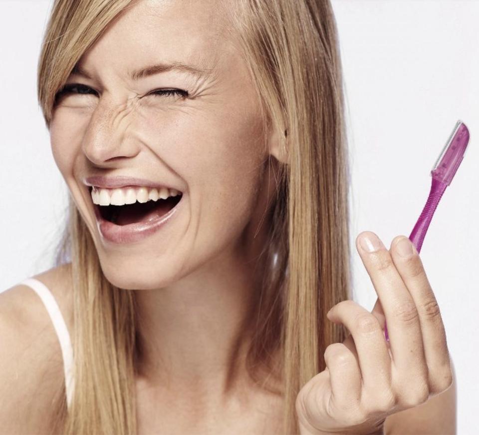 a model holding the razor in their hand