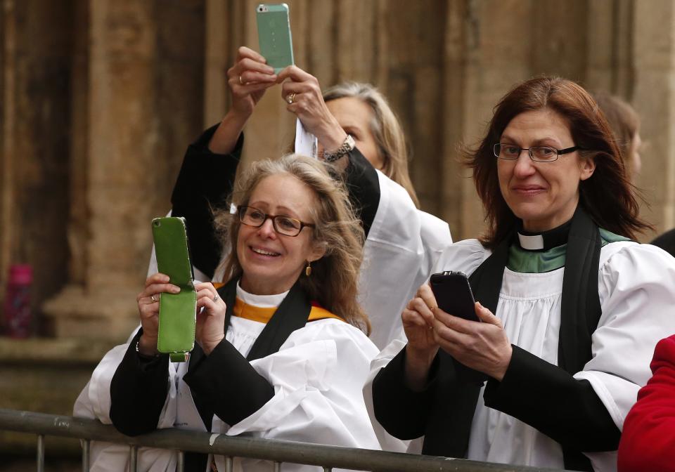 Woman clergy take photographs of the first female bishop in the Church of England Libby Lane following her consecration service at York Minster in York