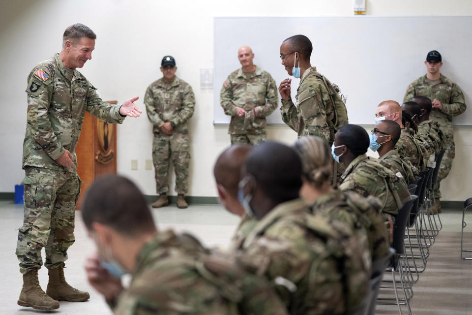 FILE - Chief of Staff of the Army Gen. James McConville left, gestures to a student in the new Army prep course at Fort Jackson, S.C., Friday, Aug. 26, 2022, as McConville visited to see the new course, an effort to better prepare recruits for the demands of basic training. The Army and Air Force say they are on track to meet their recruiting goals in 2024, reversing previous shortfalls using a swath of new programs and policy changes. But the Navy, while improving, expects once again to fall short. (AP Photo/Sean Rayford, File)