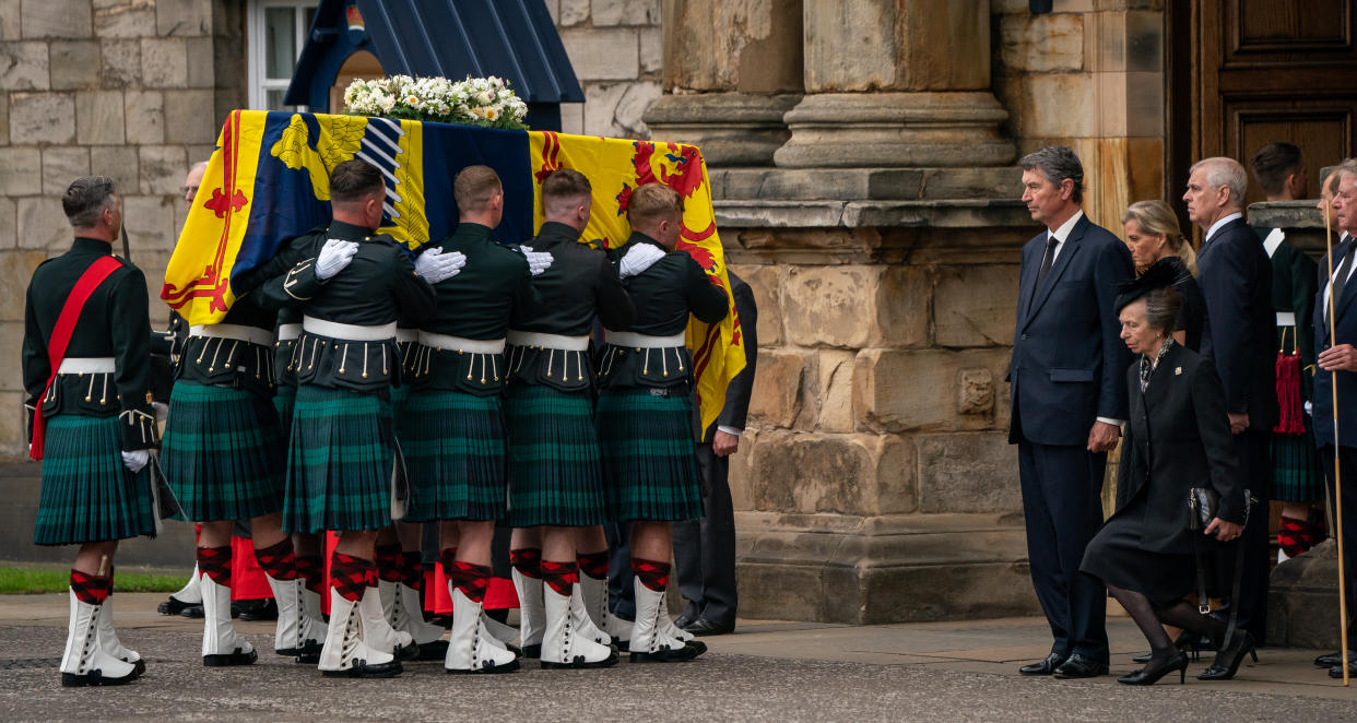 The Princess Royal curtseys the coffin of Queen Elizabeth II, draped with the Royal Standard of Scotland, as it arrives at Holyroodhouse, Edinburgh, where it will lie in rest for a day.. Picture date: Sunday September 11, 2022.