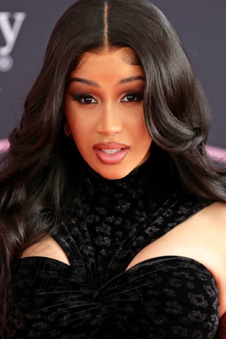 Cardi B in a black velvet dress with a high neckline and cut-out shoulders at the AMAs