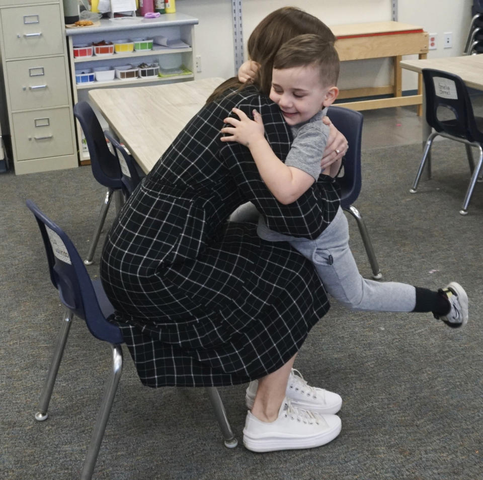 Molly Hillier, an instructional coach at Endeavor Elementary, greets her son Riggins, 4, at the school on Feb. 29, 2024, in Nampa, Idaho. Hillier is able to pop in to the onsite daycare and check on him throughout the day. (Carly Flandro/Idaho Education News via AP)