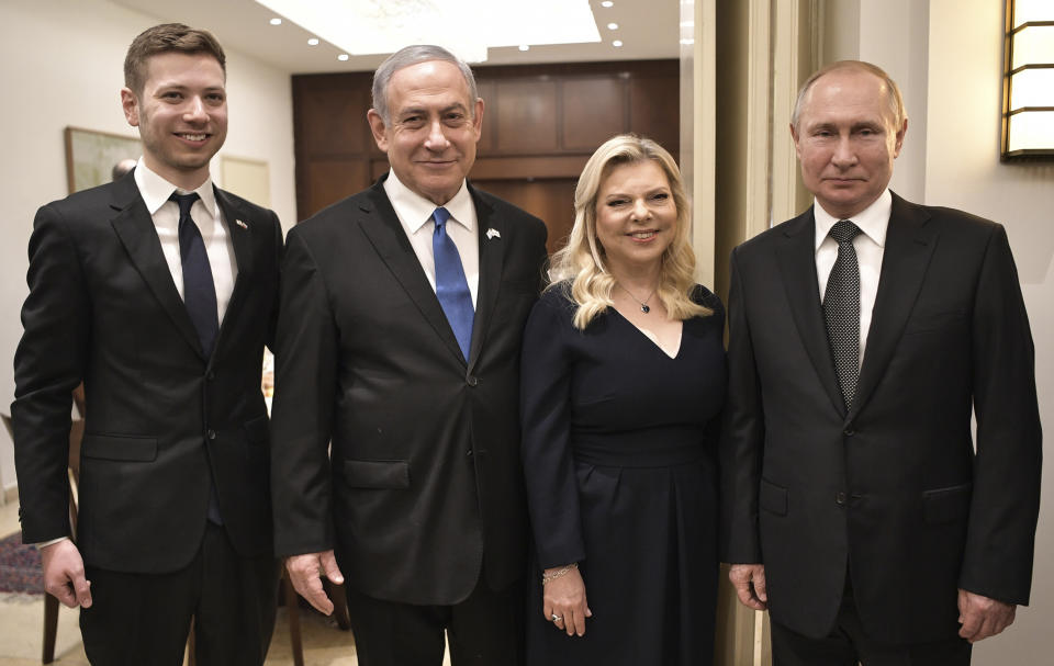 Israeli Prime Minister Benjamin Netanyahu, 2nd left, his wife Sara, son Yair, left, and Russian President Vladimir Putin pose during a meeting, in Tel-Aviv, Israel, Thursday, Jan. 23, 2020, ahead of the World Holocaust Forum, which coincides with the 75th anniversary of the liberation of the Auschwitz death camp. Dozens of world leaders have descended upon Jerusalem for the largest-ever gathering focused on commemorating the Holocaust and combating modern-day anti-Semitism. (Aleksey Nikolskyi, Sputnik Kremlin Pool Photo via AP)