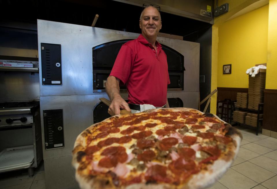 Joe Calderone, owner of Joe Daddy's Pizza in Cape Coral, displays a Neapolitan pizza pie.